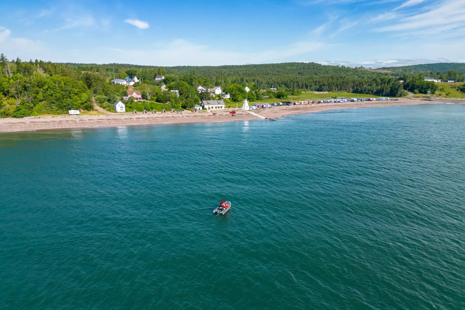 The Bay of Fundy shoreline seen from the water on a clear day
