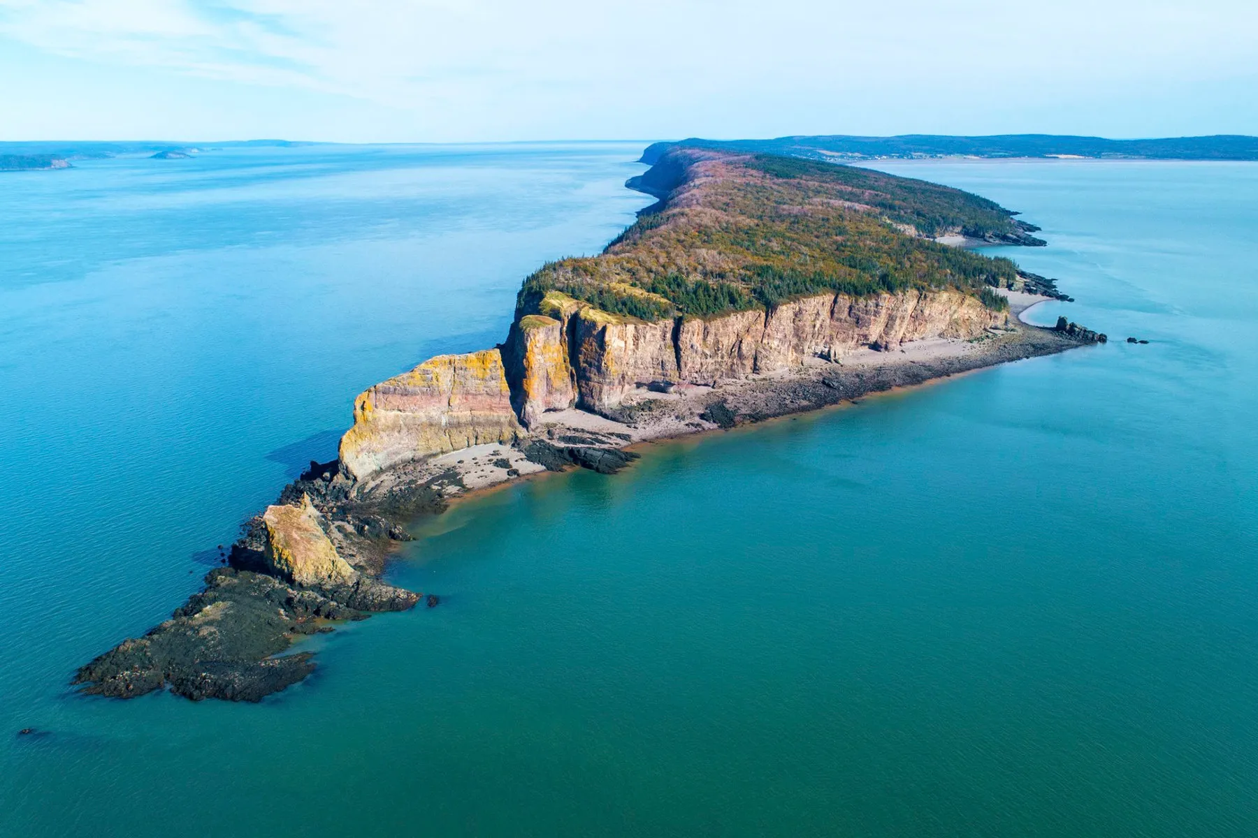 The basalt cliffs of Cape Split rising straight out of the Bay of Fundy