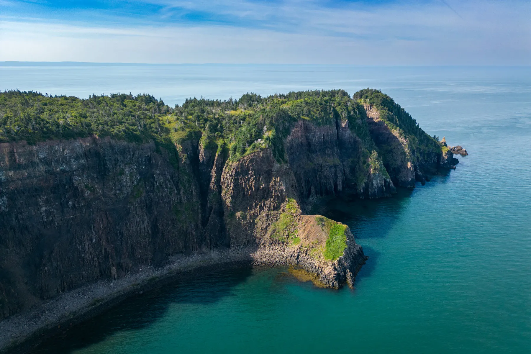 Isle Haute rising out of the Bay of Fundy through low cloud